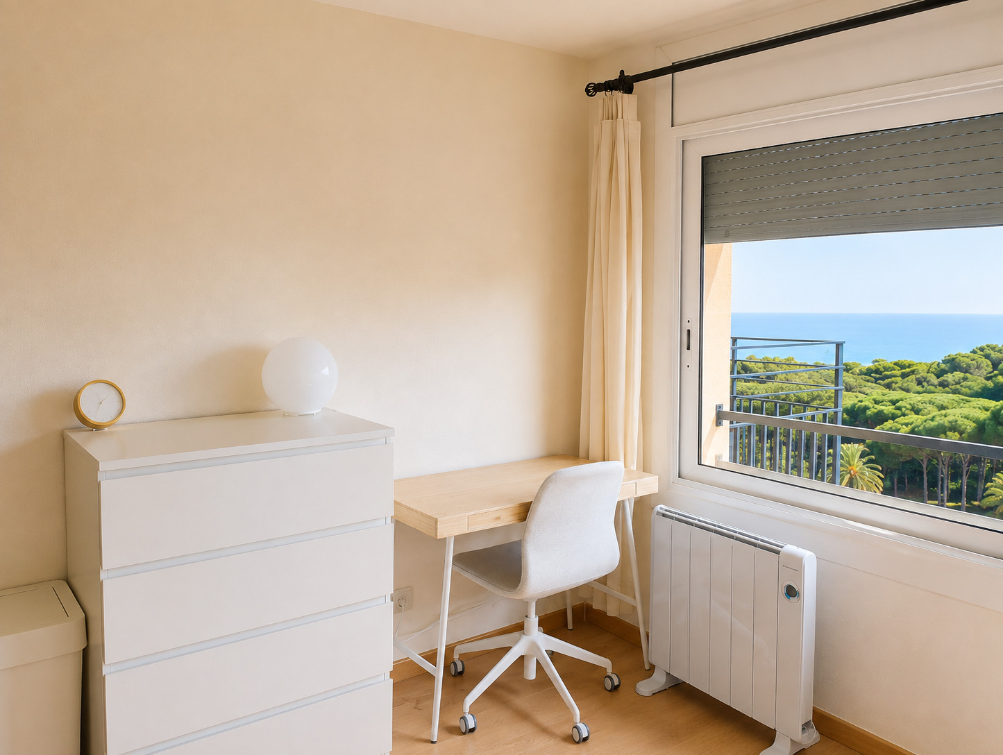 Bureau simple avec chaise, face à la fenêtre ouverte sur la végétation